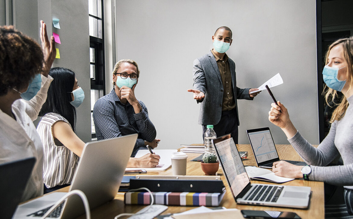 Business people wearing masks in coronavirus meeting, the new no